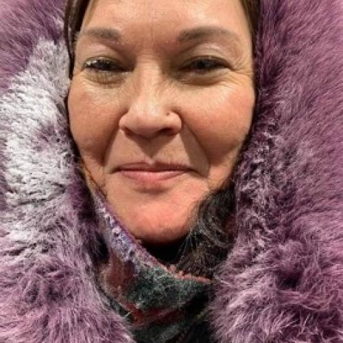 photo of Judy in a coat with purple fur